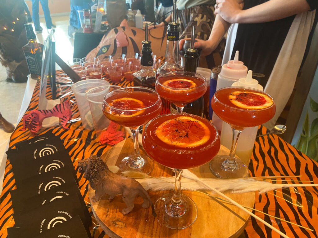 a table topped with glasses of different types of drinks