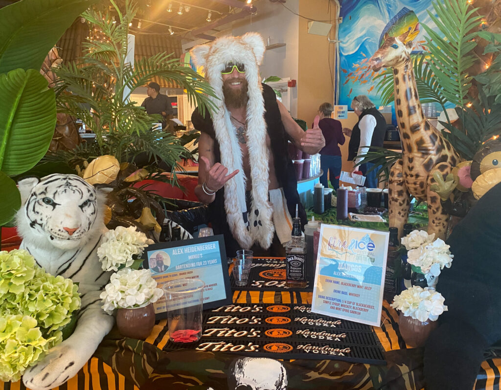 a man in a costume standing next to a table