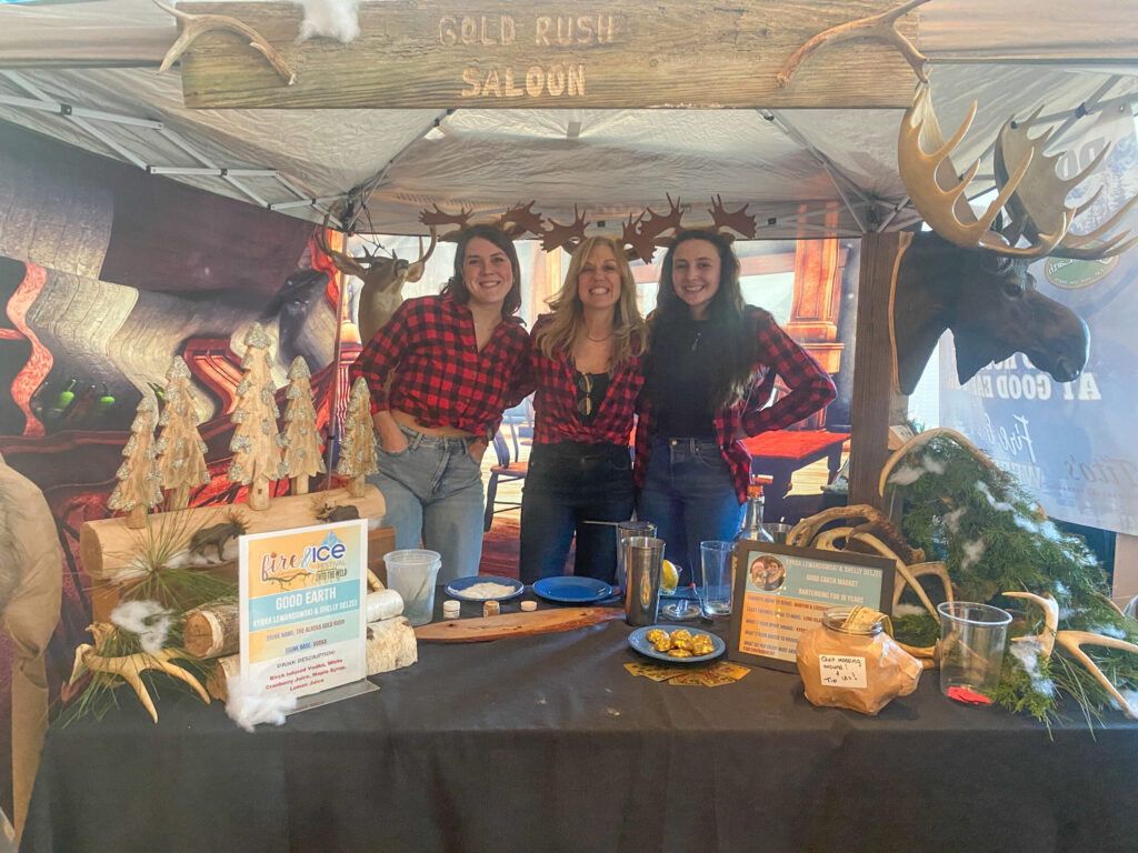 a group of women standing in front of a table