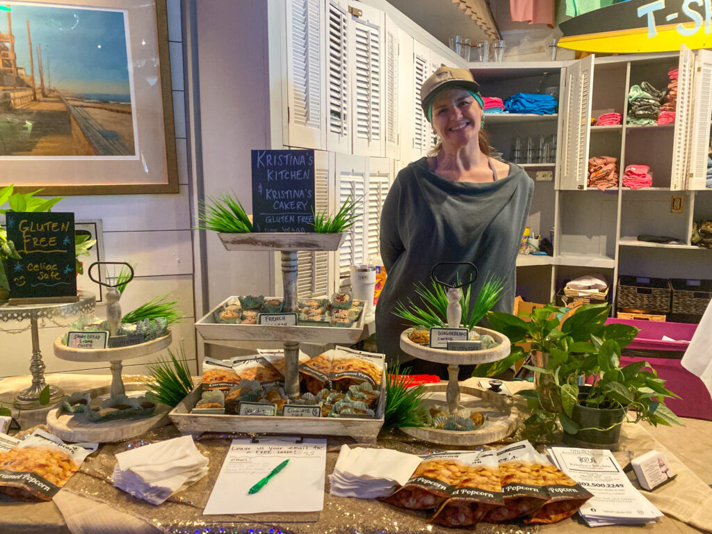a woman standing in front of a table full of food
