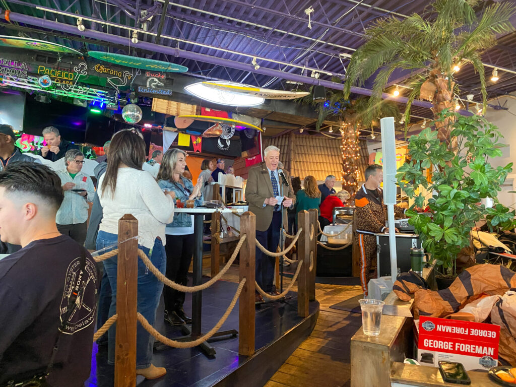 a group of people standing around a bar