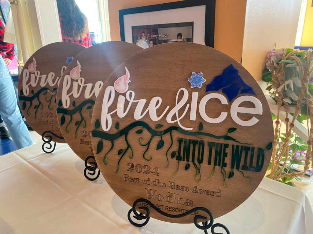 a couple of wooden signs sitting on top of a table