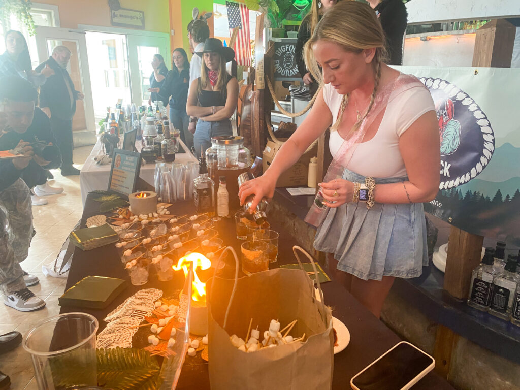 a woman standing at a bar pouring a drink