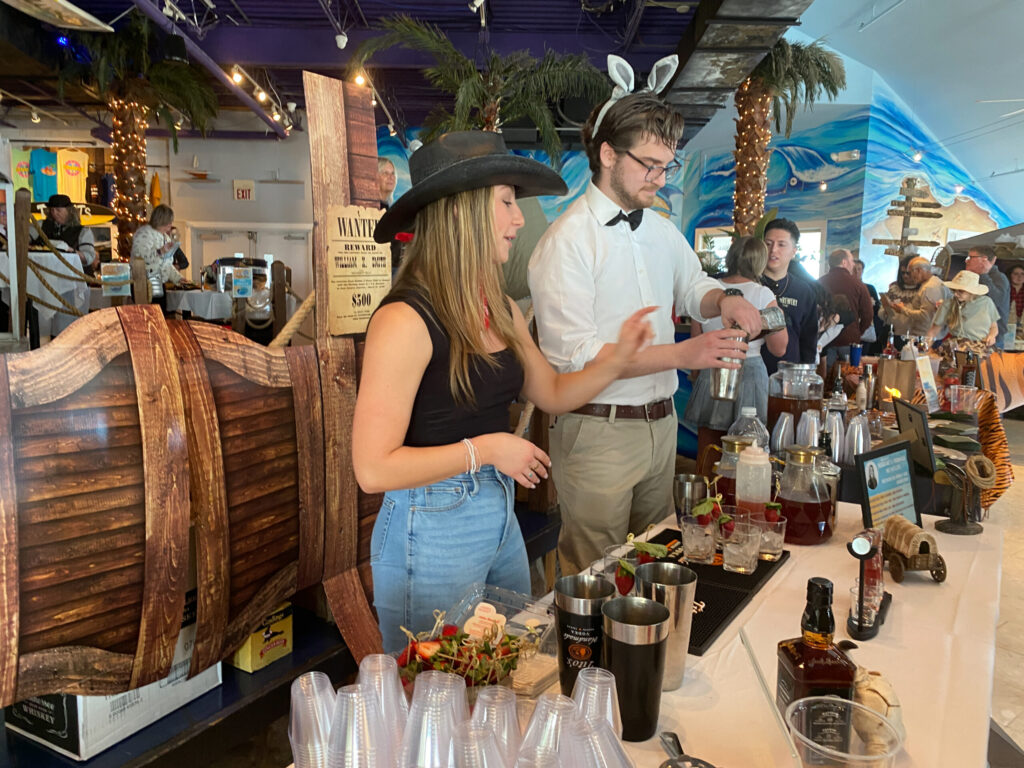 a group of people standing around a bar