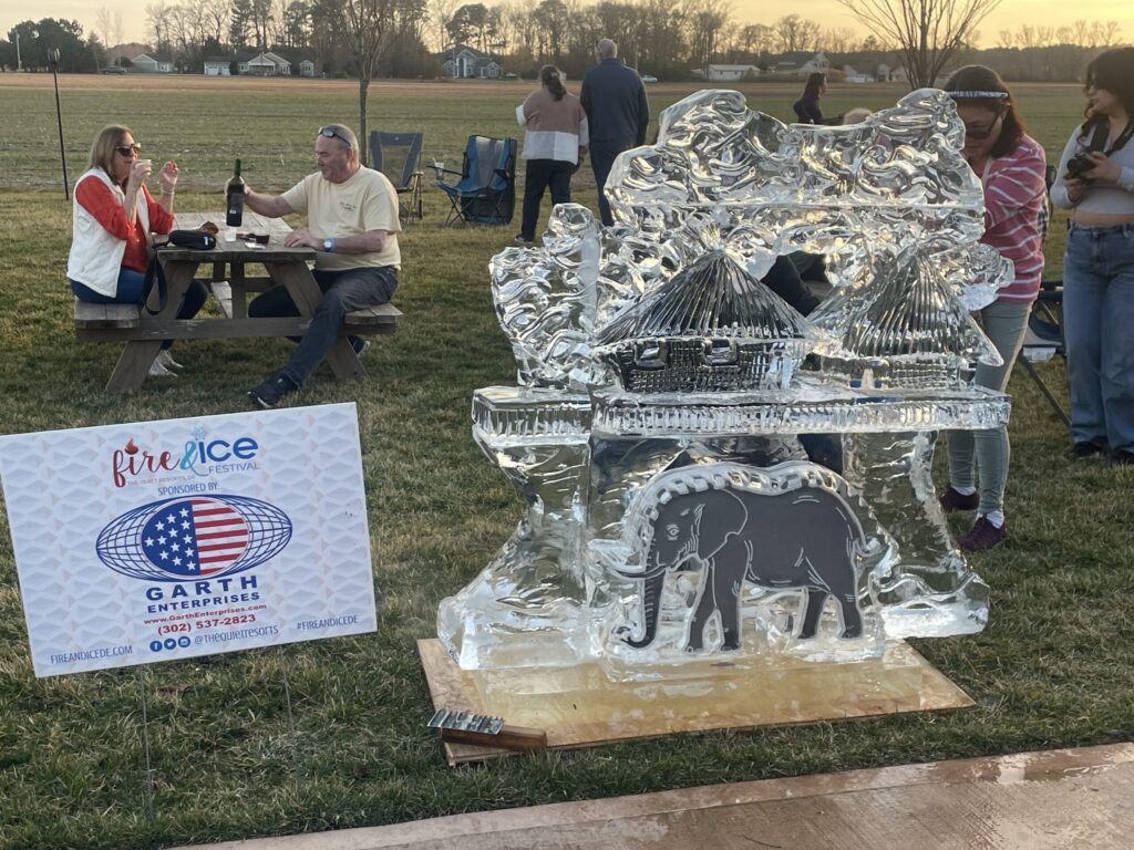 a group of people standing around an ice sculpture
