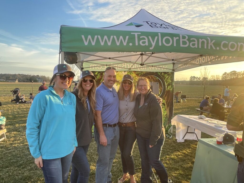 a group of people standing under a tent