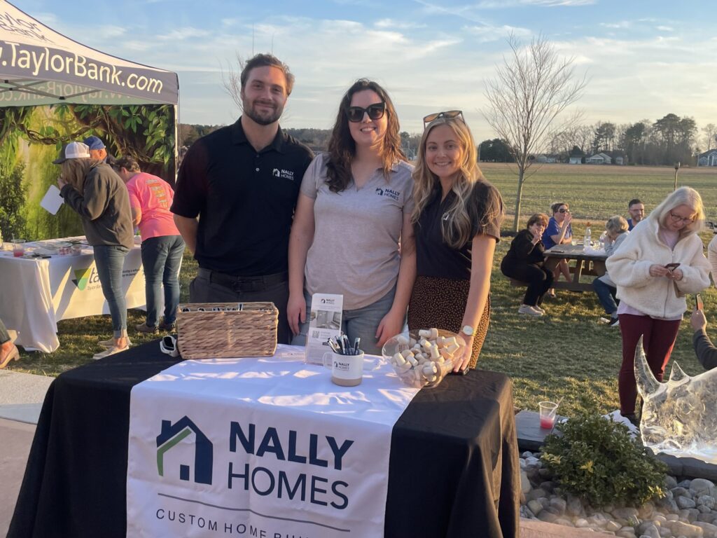 a group of people standing around a table