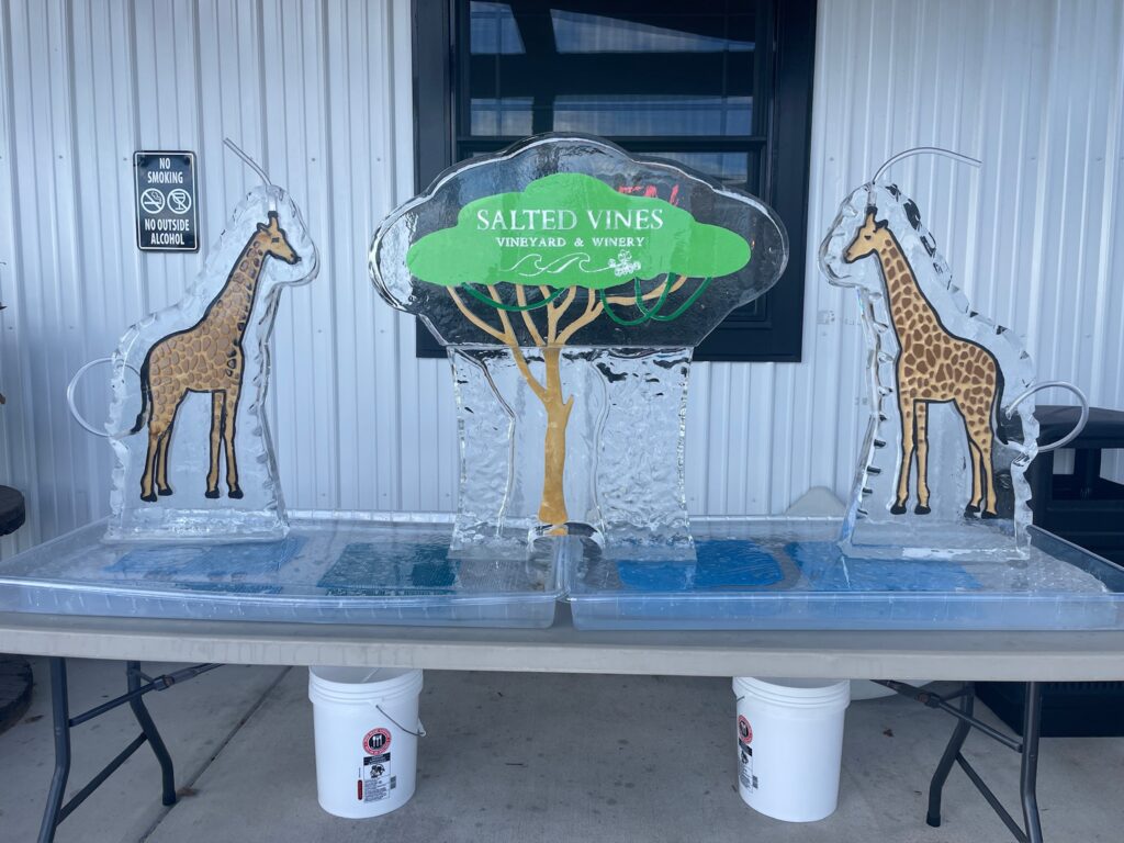 a table with two giraffes and a tree on it