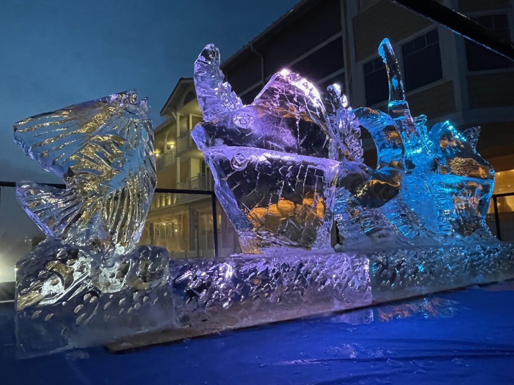 a large ice sculpture sitting on top of a snow covered ground