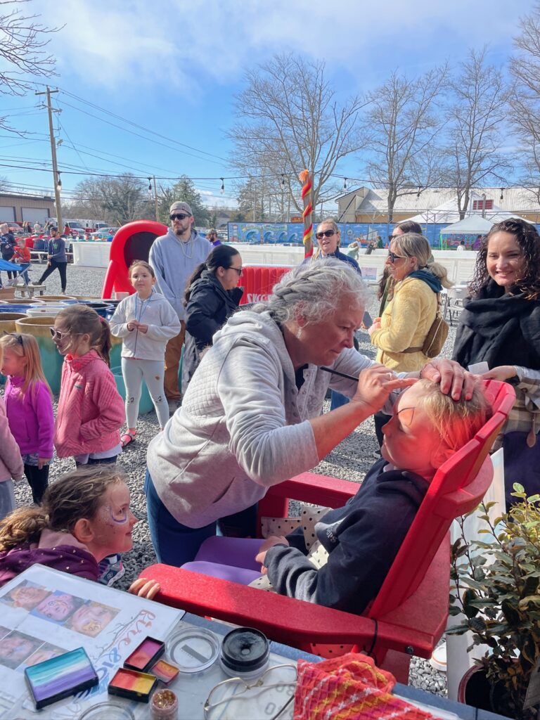 a group of people standing around a table