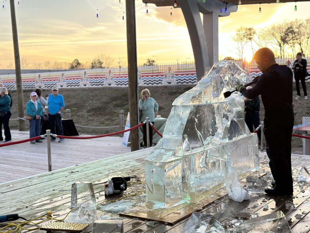 a group of people standing around an ice sculpture