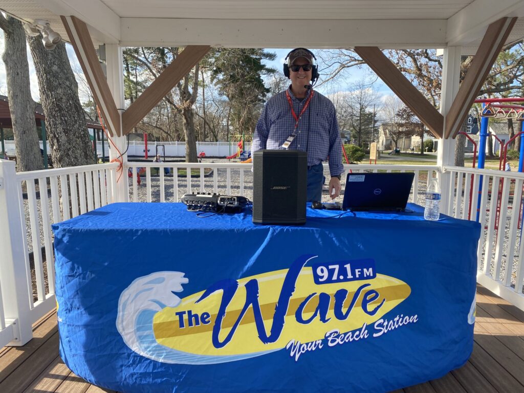 a man standing at a table with a laptop on it