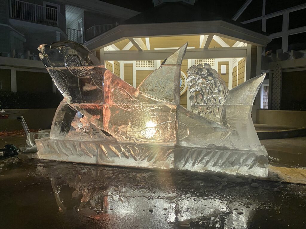 a large ice sculpture of a man on a boat in front of a building