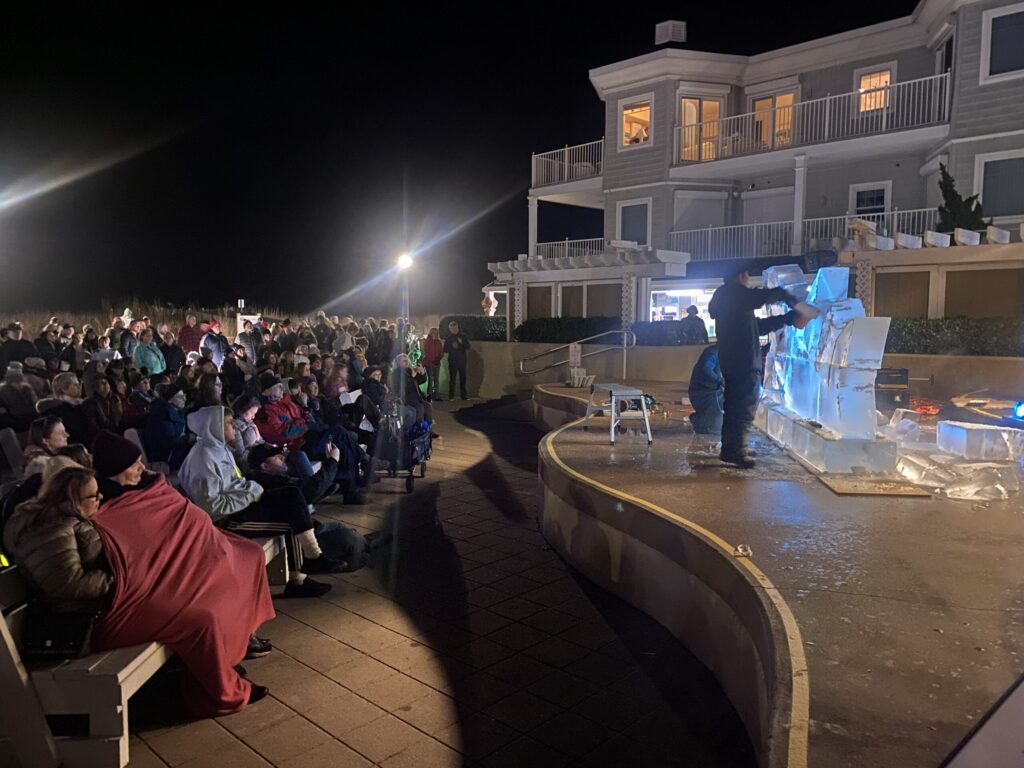 a man standing on top of a stage in front of a crowd