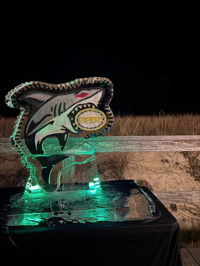 a lighted sculpture of a shark on a table