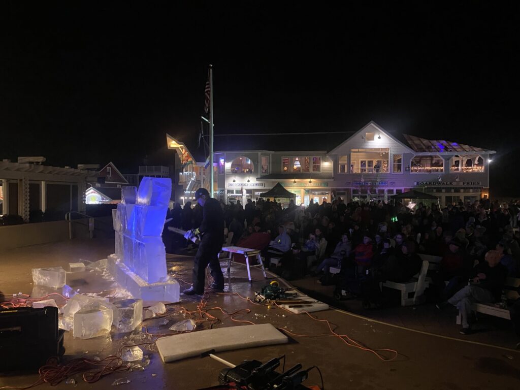 a man standing on top of a stage in front of a crowd