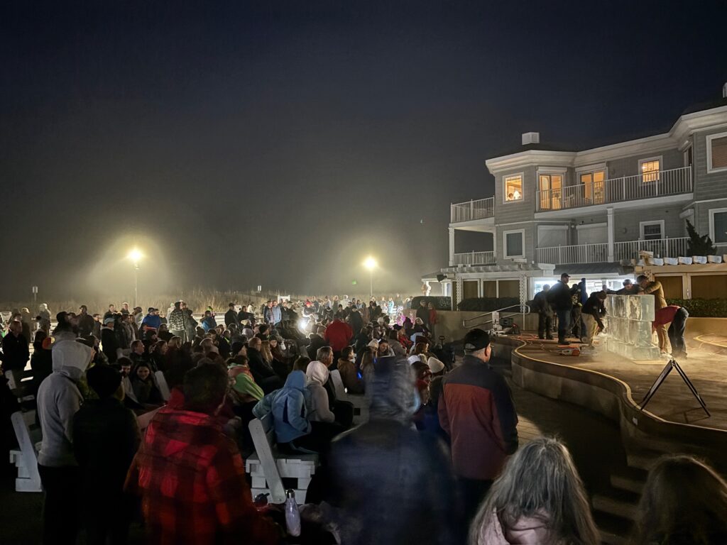 a crowd of people standing around a stage