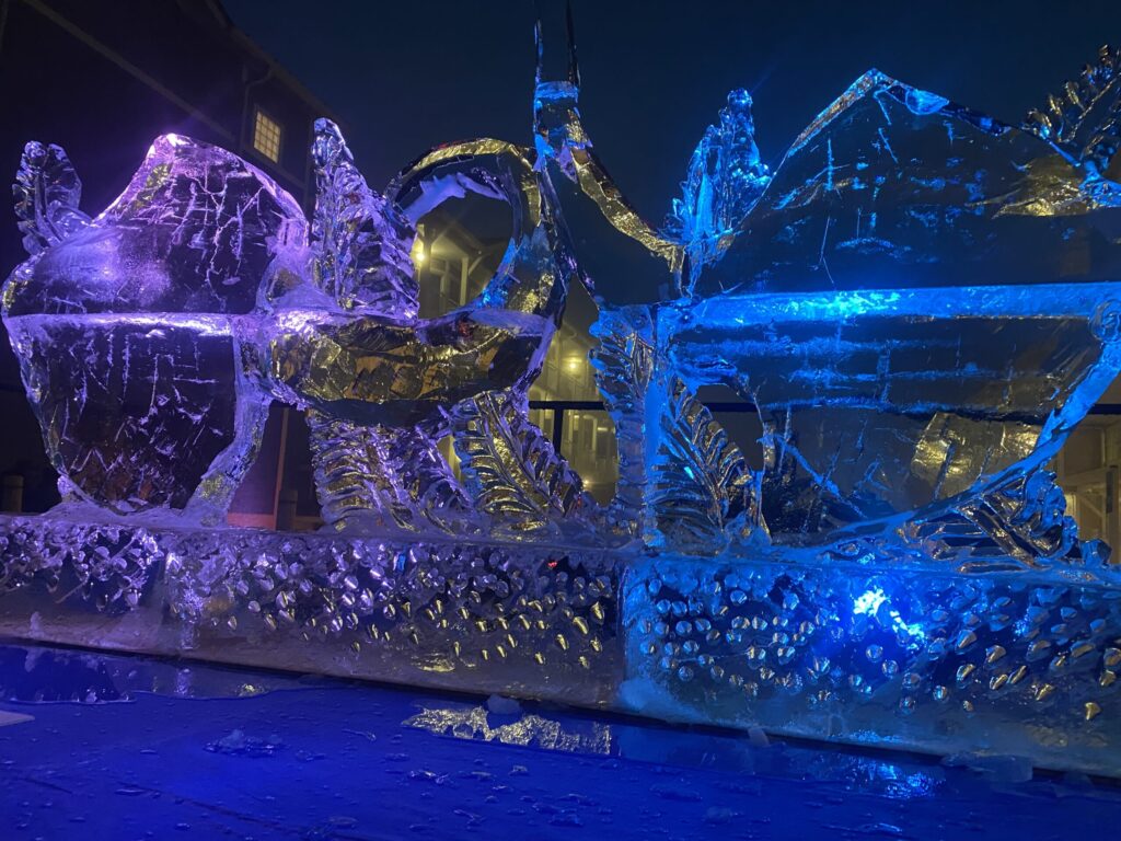 a large ice sculpture of a horse drawn carriage