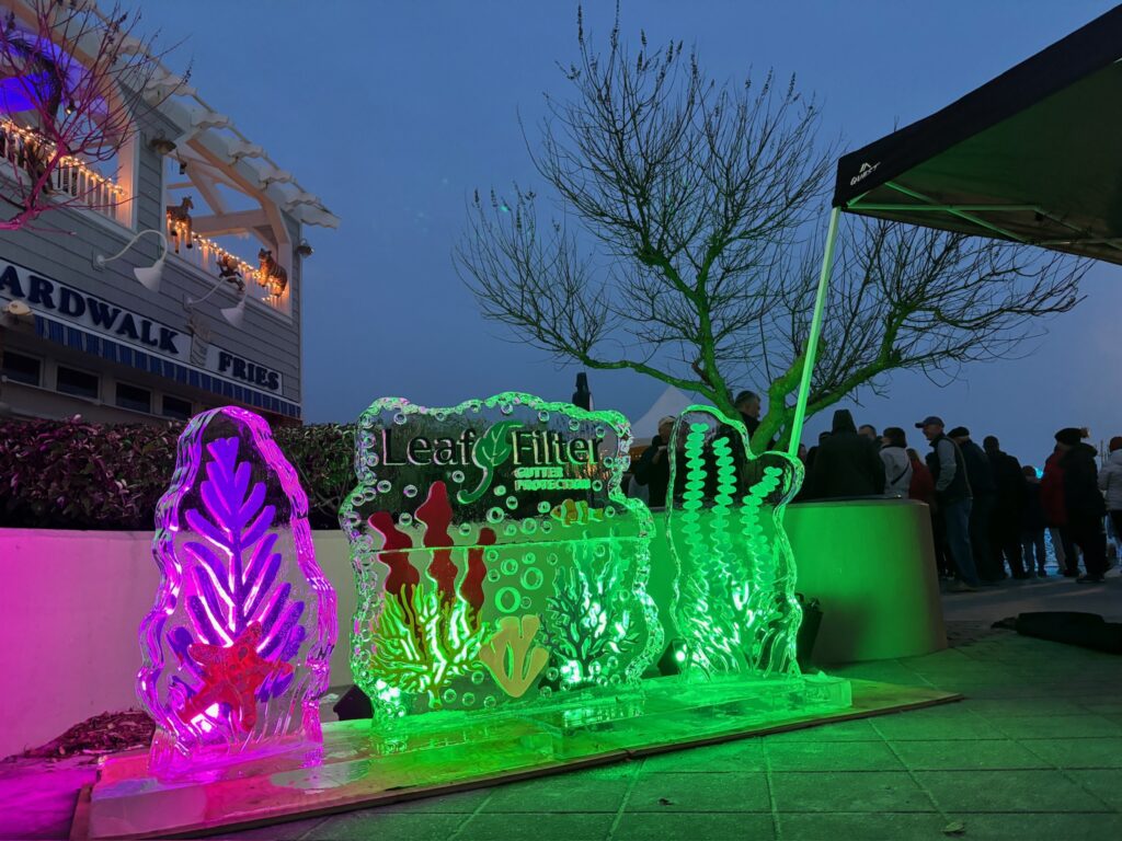 a group of people standing around a display of ice sculptures