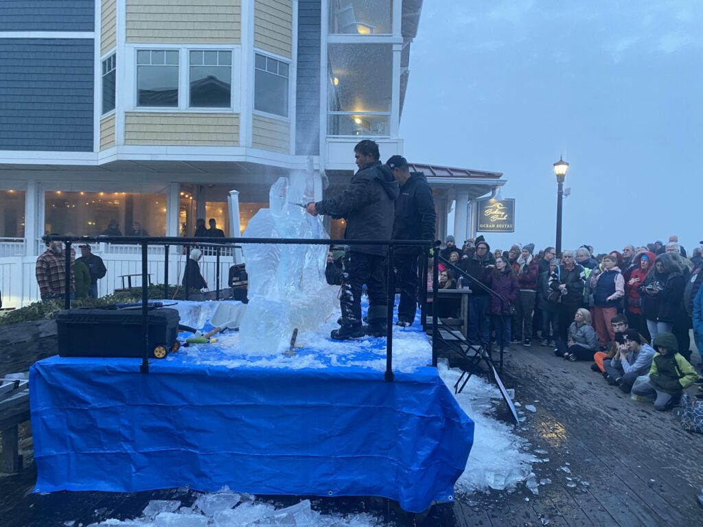a group of people standing around a blue table