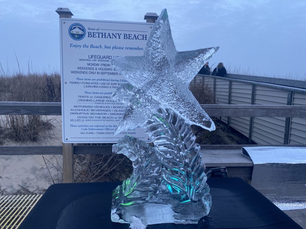 a large ice sculpture of a star on a beach