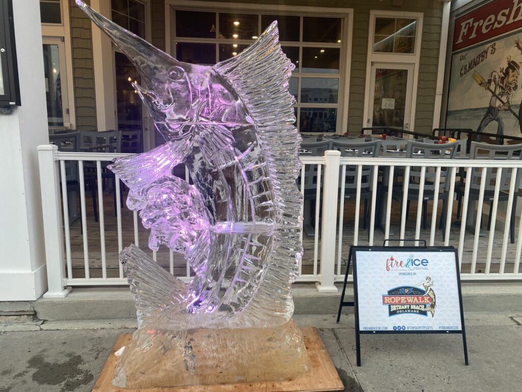 a sculpture of a bird on a wooden block