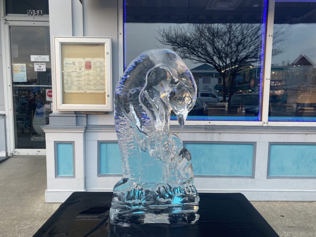 a glass sculpture of a bear in front of a building