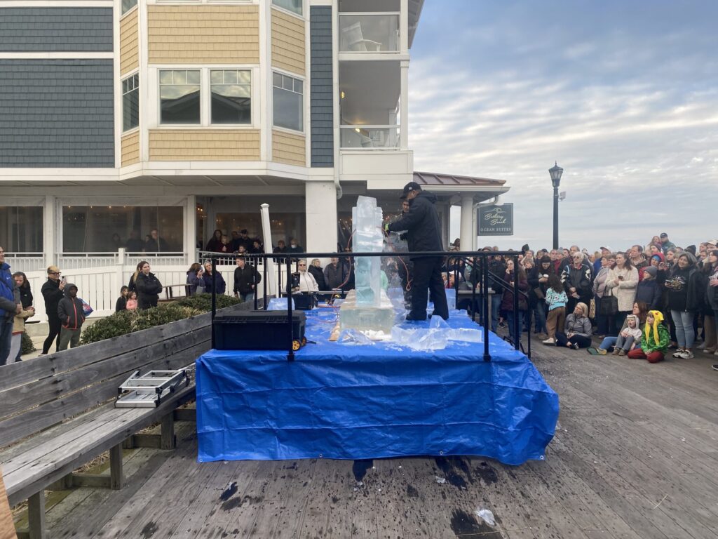 a group of people standing on a wooden pier