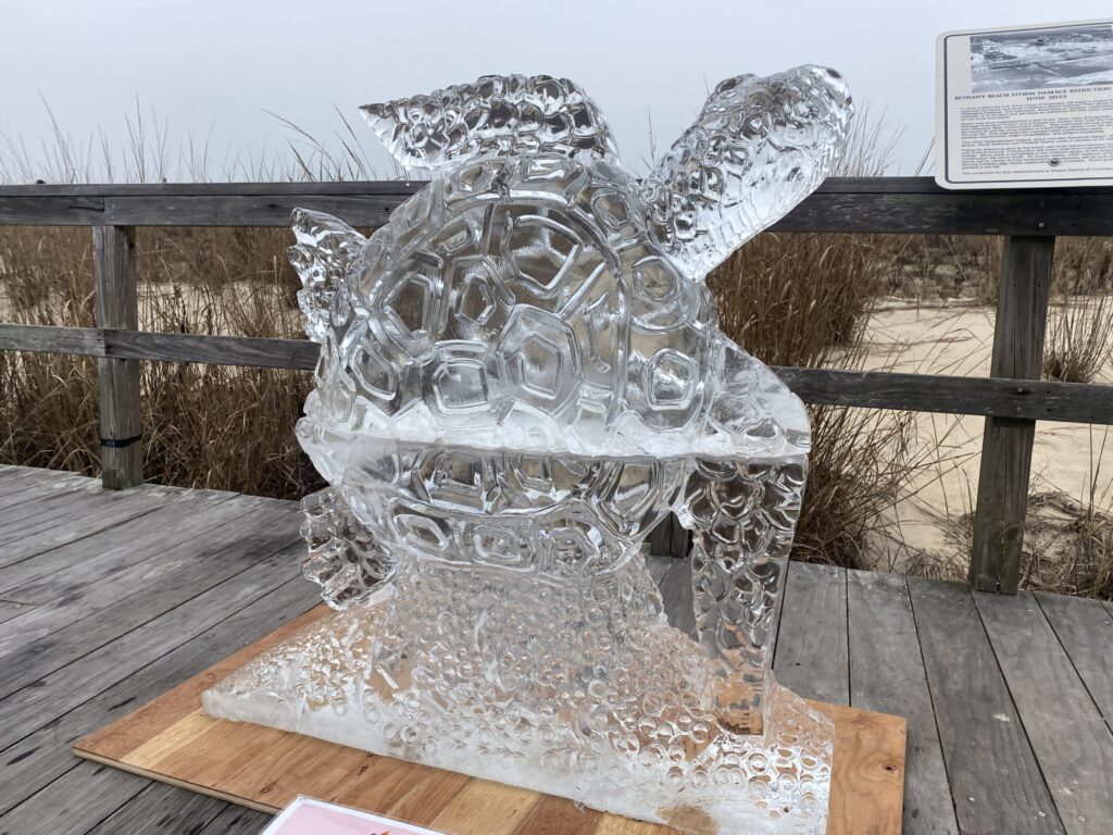 a sculpture of a bear on a wooden platform