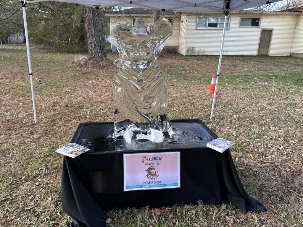 a glass sculpture on a table under a tent