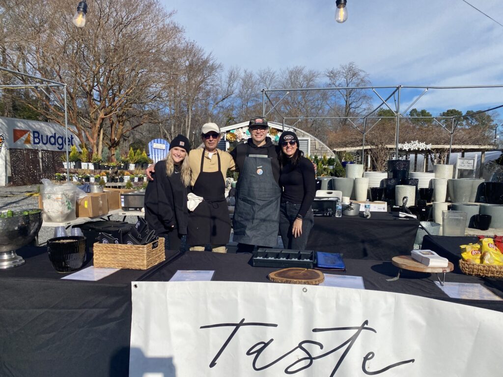 a group of people standing in front of a table