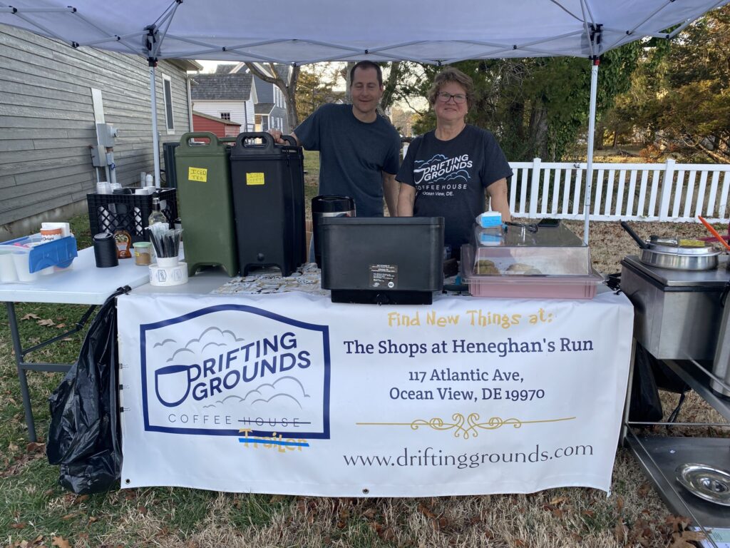 a man and a woman standing under a tent