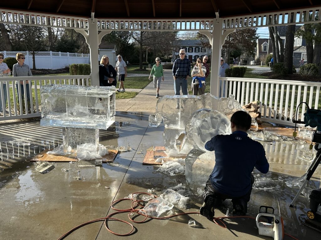 a group of people standing around a white gazebo