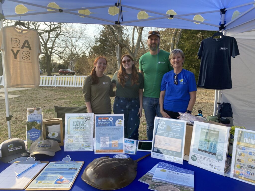 a group of people standing under a tent