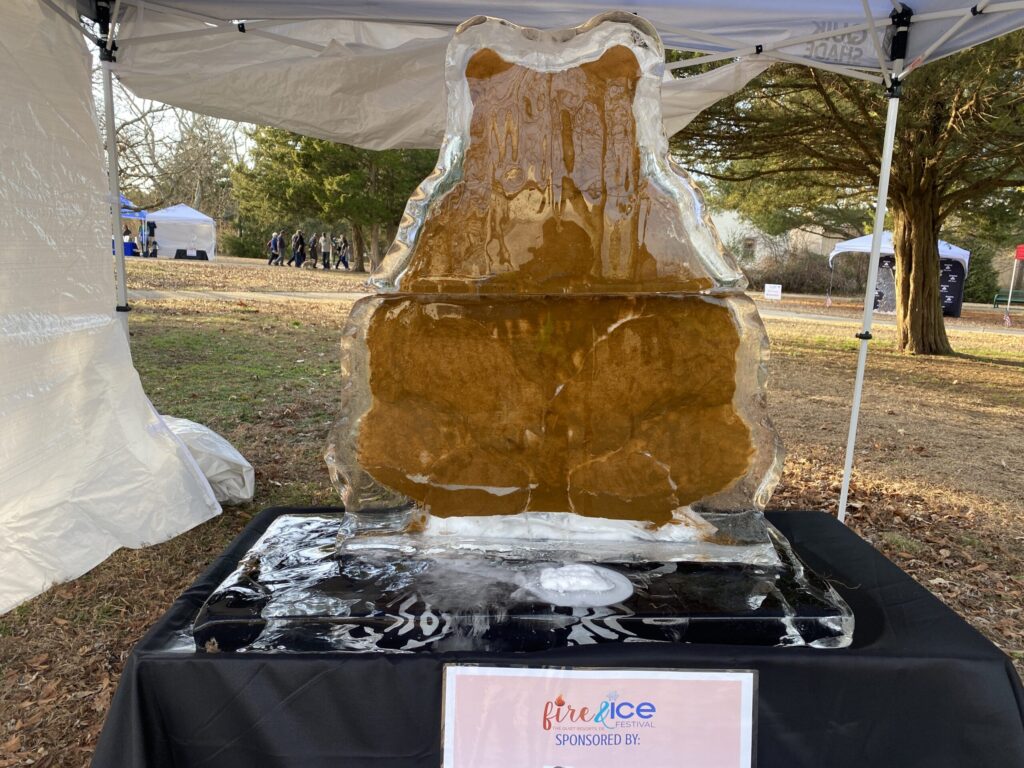 a sculpture of a bear is on display under a tent