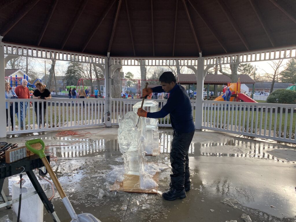 a man standing in front of a white gazebo