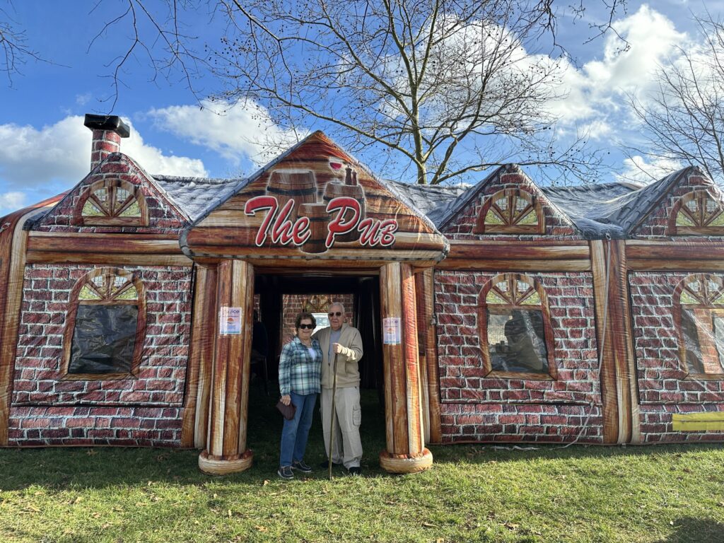 two people standing outside of a brick building