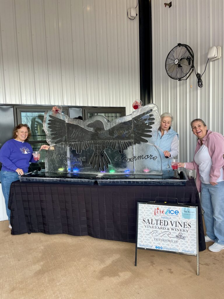 a group of people standing around a table
