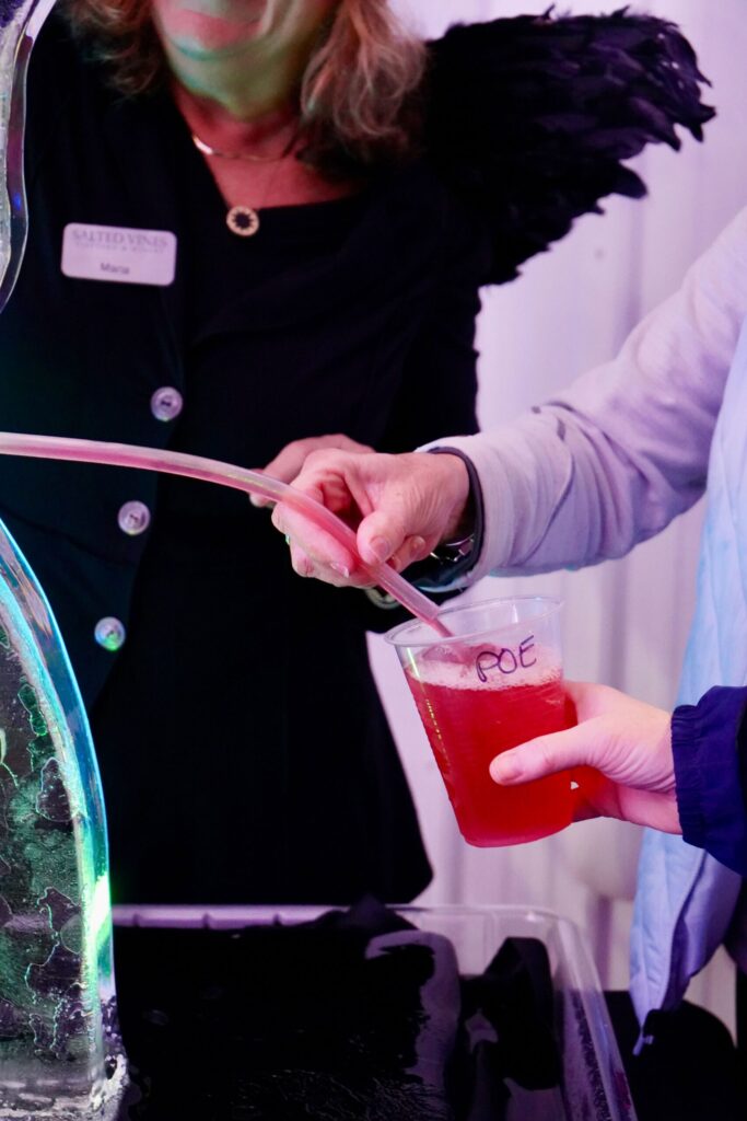 a woman is pouring liquid into a vase