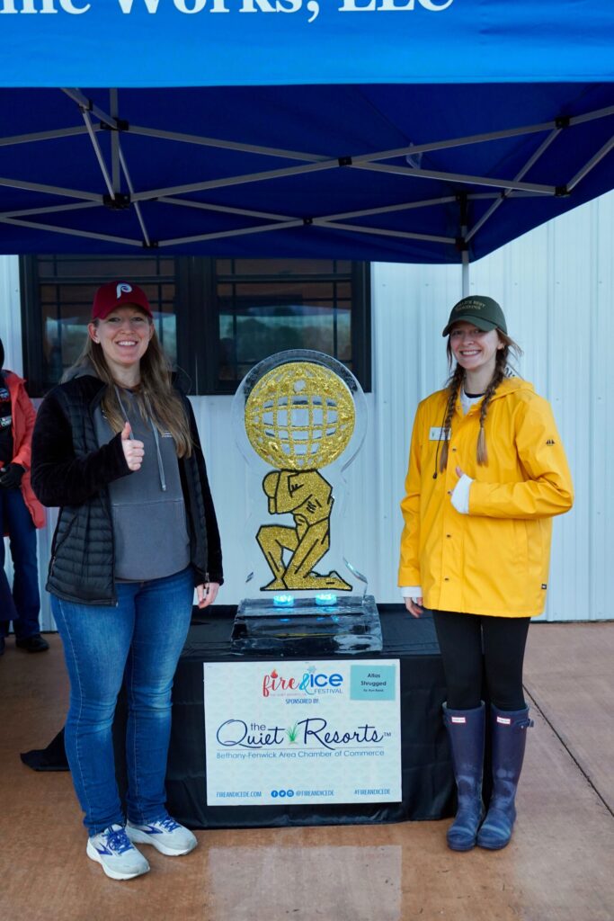 a couple of women standing next to each other under a tent