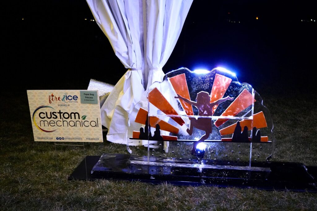 a sculpture of an american flag in the grass