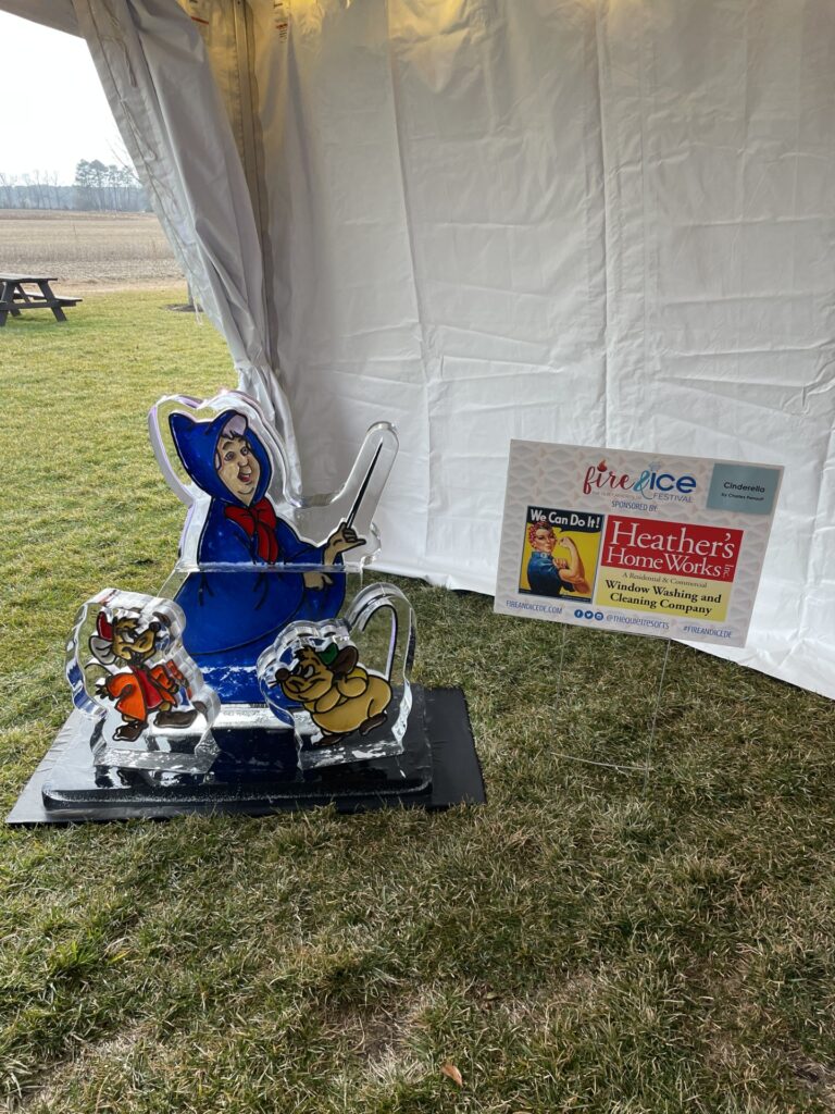 a sculpture of a person in a chair under a tent