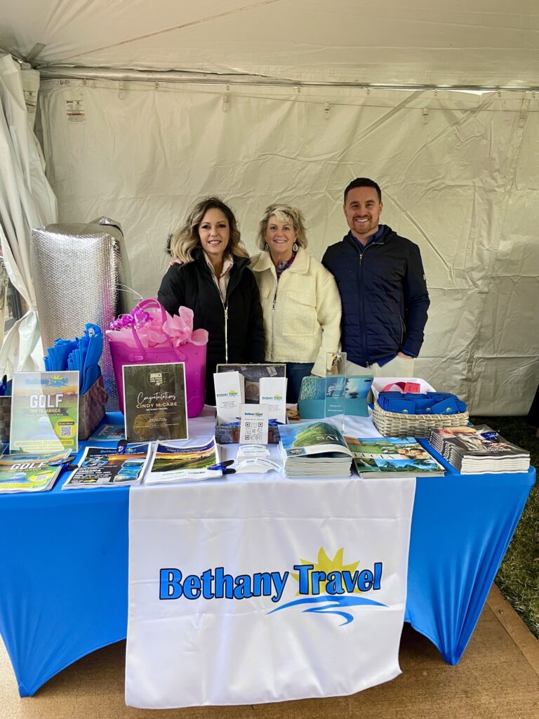 a group of people standing next to a table