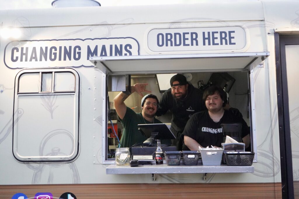 a group of people sitting inside of a food truck