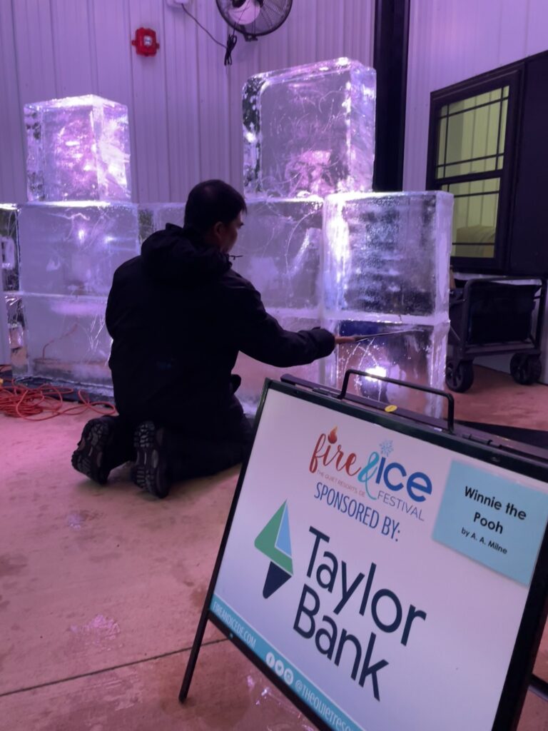 a man sitting on the floor next to a sign