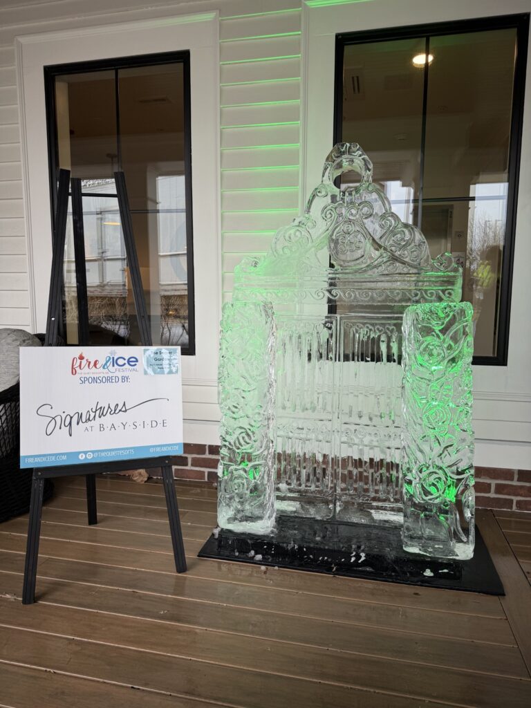 a large ice sculpture on a wooden floor in front of a building