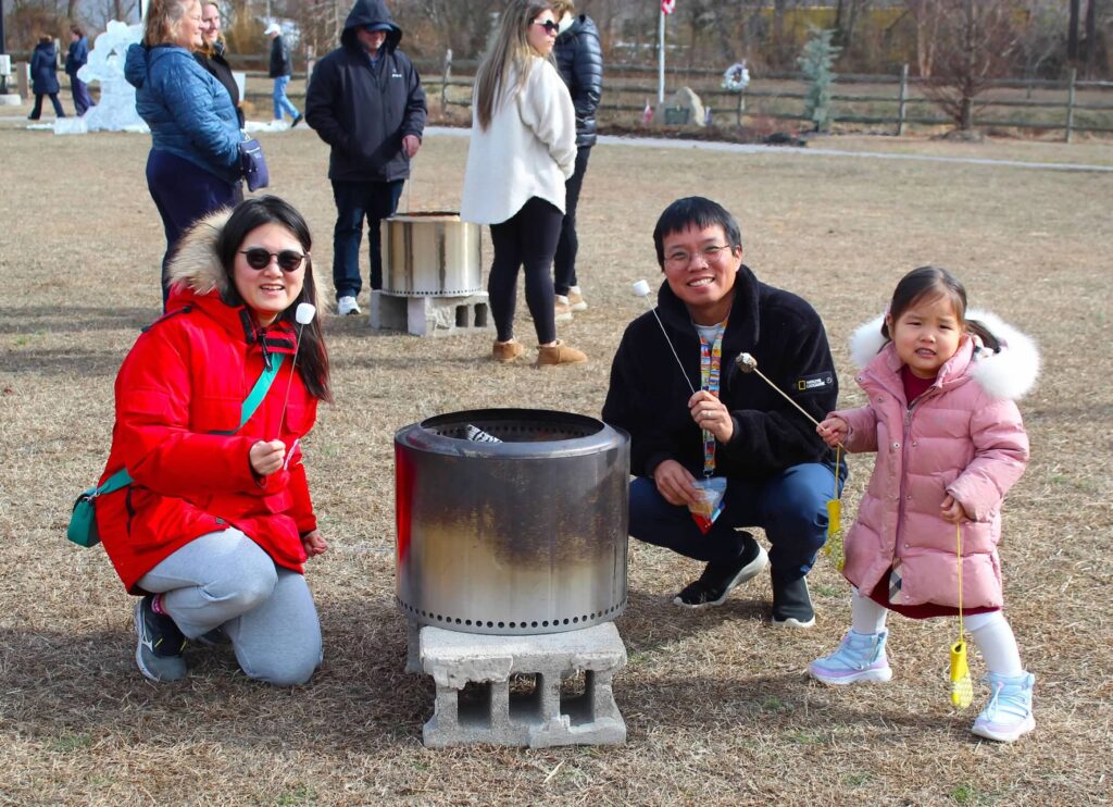 a group of people sitting around a fire pit