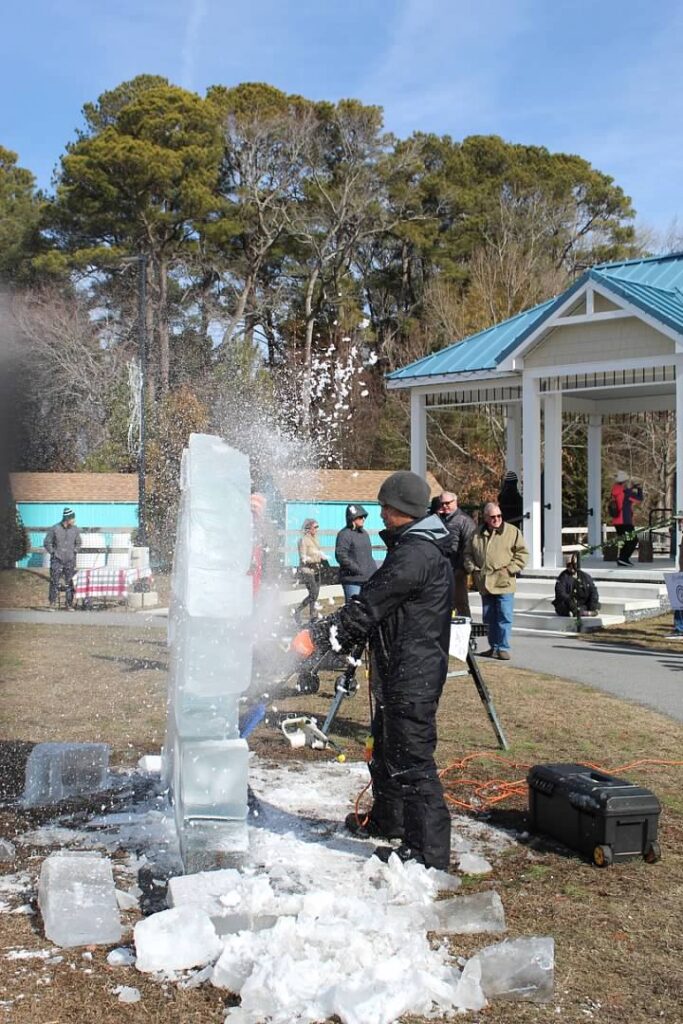 a group of people standing around an ice sculpture