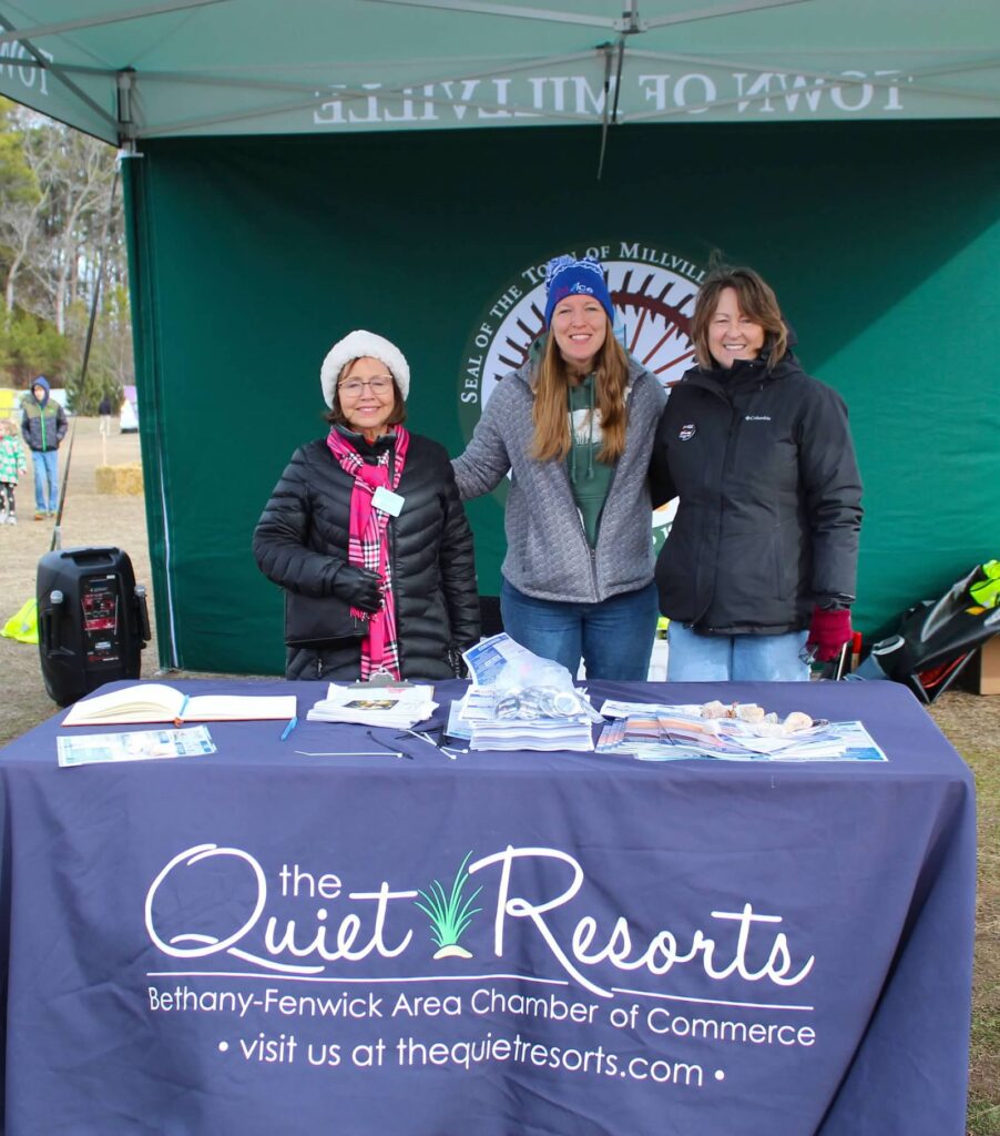 three women standing in front of a table