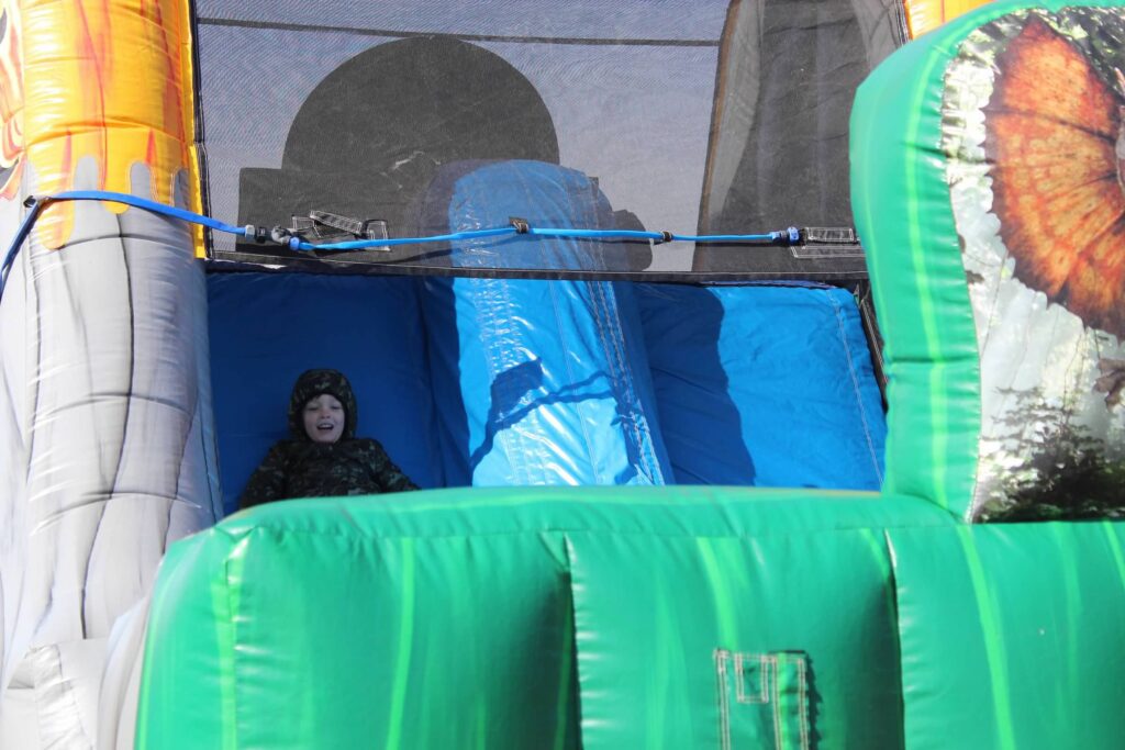 an inflatable slide with a person sitting on top of it
